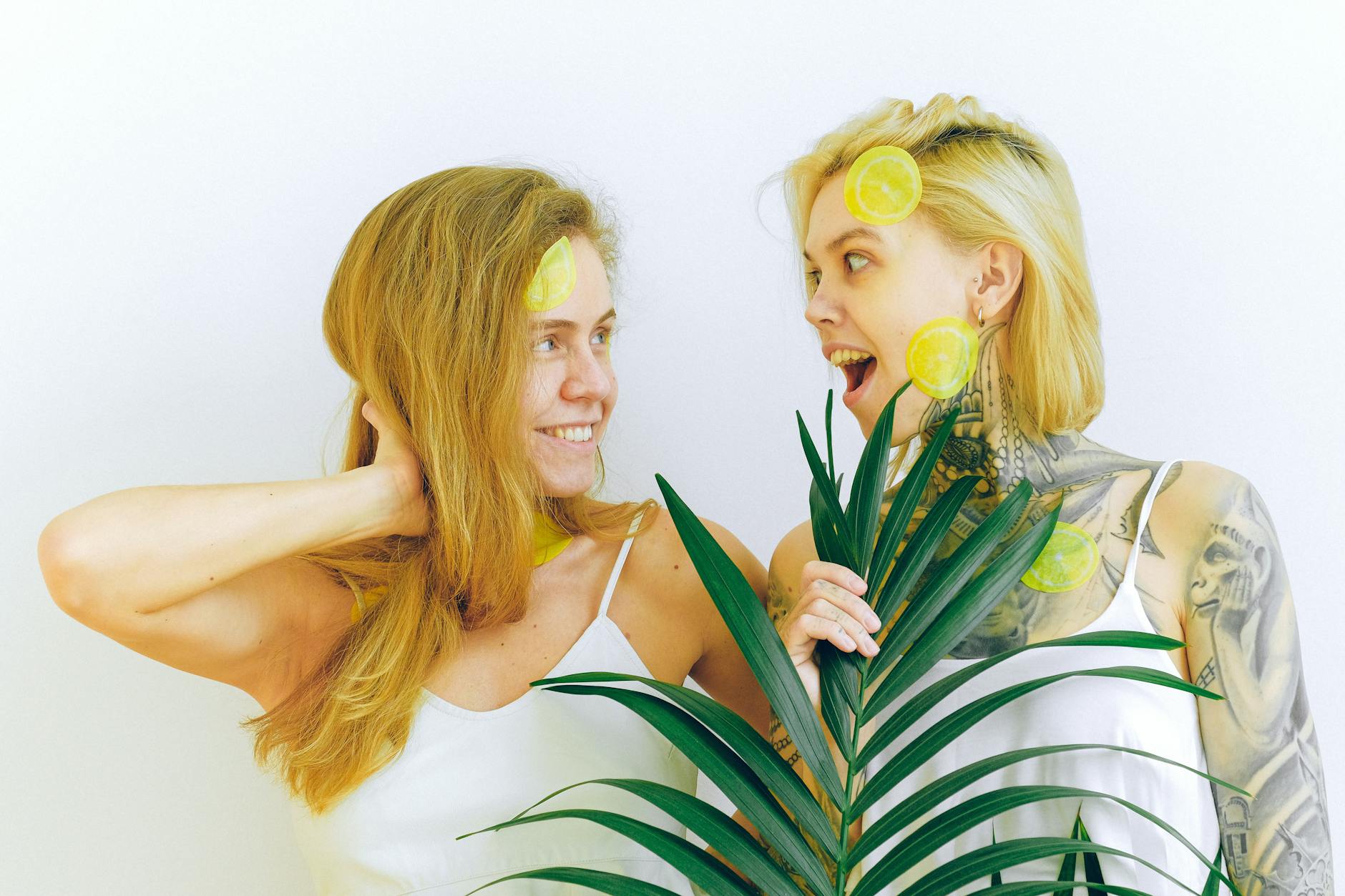 Two women smiling with joy and confidence during a moment of connection indoors
