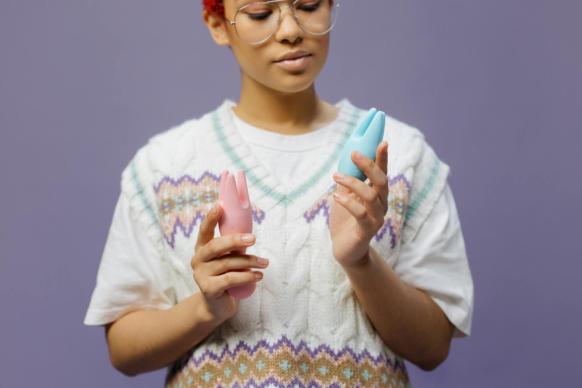 Close-up of hands holding a personal massager, symbolizing the rediscovery of intimacy and touch.